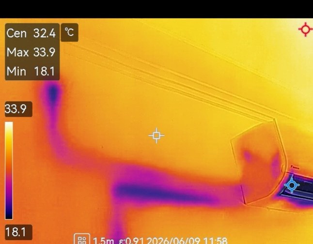Thermal image of the living-room wall around the air-conditioning unit in the Section 9 house, a cold plume down to 18.1 degrees snaking across a 33 degree wall
